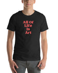 Man wearing black heather Milk Sandwich T-shirt with bold red All Of Life Is Art slogan, minimalist graphic tee with retro typography on white background.