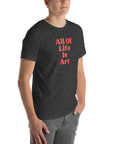 Angled view of man wearing dark grey heather Milk Sandwich T-shirt with bold red All Of Life Is Art text, modern unisex graphic tee with vintage font.