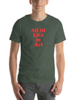 Man wearing heather forest Milk Sandwich T-shirt with bold red All Of Life Is Art slogan, minimalist graphic tee with retro typography on white background.