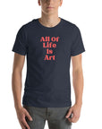 Man wearing heather navy Milk Sandwich T-shirt with bold red All Of Life Is Art slogan, minimalist graphic tee with retro typography on white background.