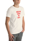 Angled view of man wearing vintage white Milk Sandwich T-shirt with bold red All Of Life Is Arttext, modern unisex graphic tee with vintage font.