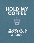 Close-up of teal Milk Sandwich T-shirt with white bold text Hold My Coffee, I'm About to Prove You Wrong and a cute steaming coffee cup graphic.