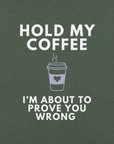 Close-up of forest Milk Sandwich T-shirt with white bold text Hold My Coffee, I'm About to Prove You Wrong and a cute steaming coffee cup graphic.