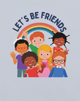 Close-up of a light blue Milk Sandwich t-shirt with a colorful print showing six diverse cartoon children smiling and waving under a rainbow, with the text "LET'S BE FRIENDS" above them.