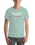 Man wearing heather prism dusty blue Milk Sandwich T-shirt with bold white and red text reading Not Today Satan (But Friday Looks Open), funny slogan tee on white background.