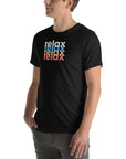 Side view of a man wearing a Milk Sandwich black t-shirt featuring a stacked relax text design in distressed white, blue, orange, and pink colors.
