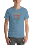 Man wearing a Milk Sandwich steel blue t-shirt with a colorful retro-style "ROUND EARTH SOCIETY" graphic and globe icon on the front.