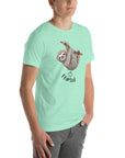 Side view of a man wearing a mint Milk Sandwich t-shirt featuring a playful cartoon sloth hanging from a branch with the phrase I farted and a small puff cloud illustration underneath.