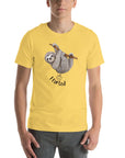 Man wearing a yellow Milk Sandwich t-shirt with a smiling cartoon sloth hanging from a branch and the humorous phrase I farted below a small illustrated puff cloud.