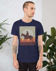 Unisex navy t-shirt featuring a cowboy silhouette against a sunset, surrounded by cacti, ideal for casual wear.