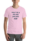 Man wearing lilac “DON’T BE A PEE PEE POO POO HEAD” t-shirt, standing casually with hands by pockets.