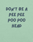 Man wearing mint “DON’T BE A PEE PEE POO POO HEAD” t-shirt, standing casually with hands by pockets.