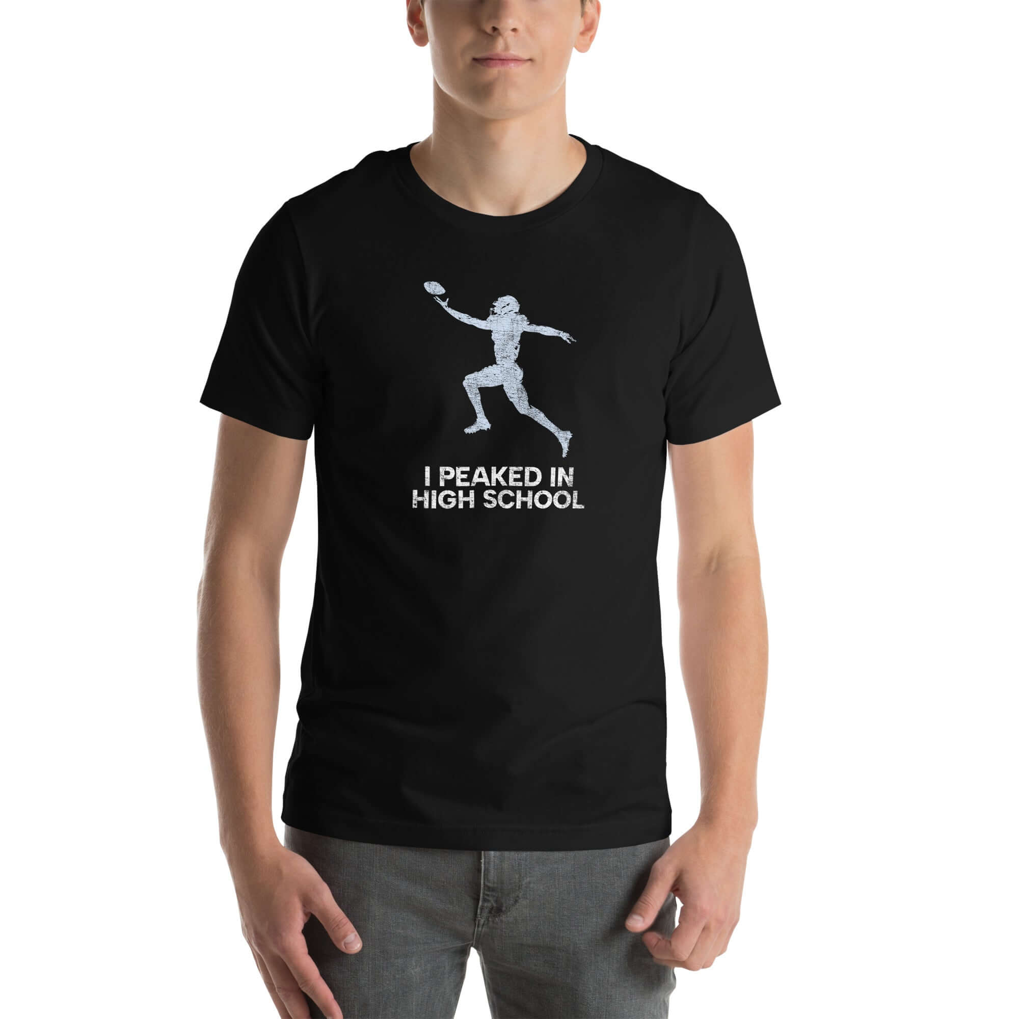 Man wearing "I Peaked in High School Football" unisex Milk Sandwich T-shirt, perfect for tailgates and sports movie nights.