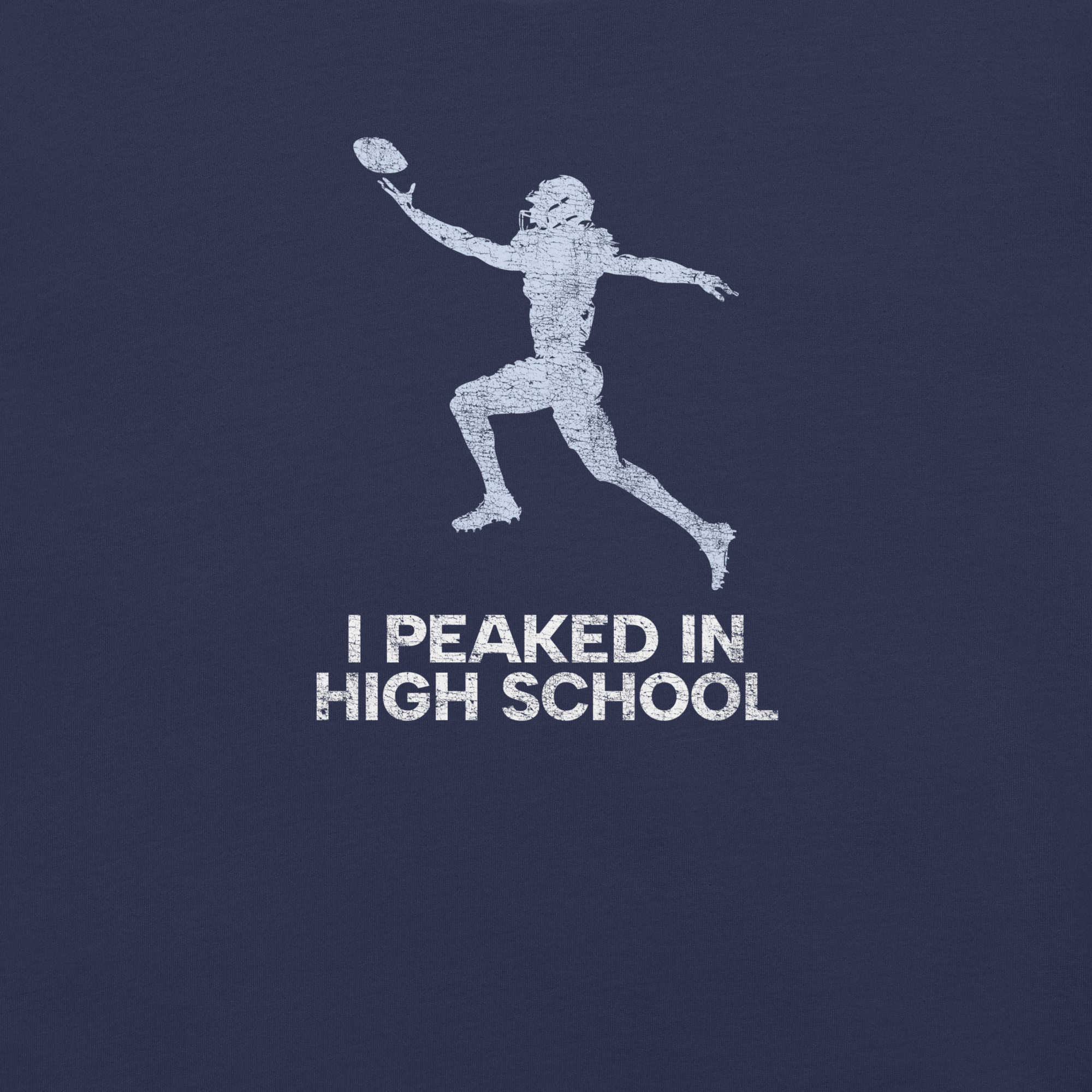 Close-up of navy Milk Sandwich T-shirt with distressed white football player graphic and text I Peaked in High School, ironic athletic nostalgia tee.