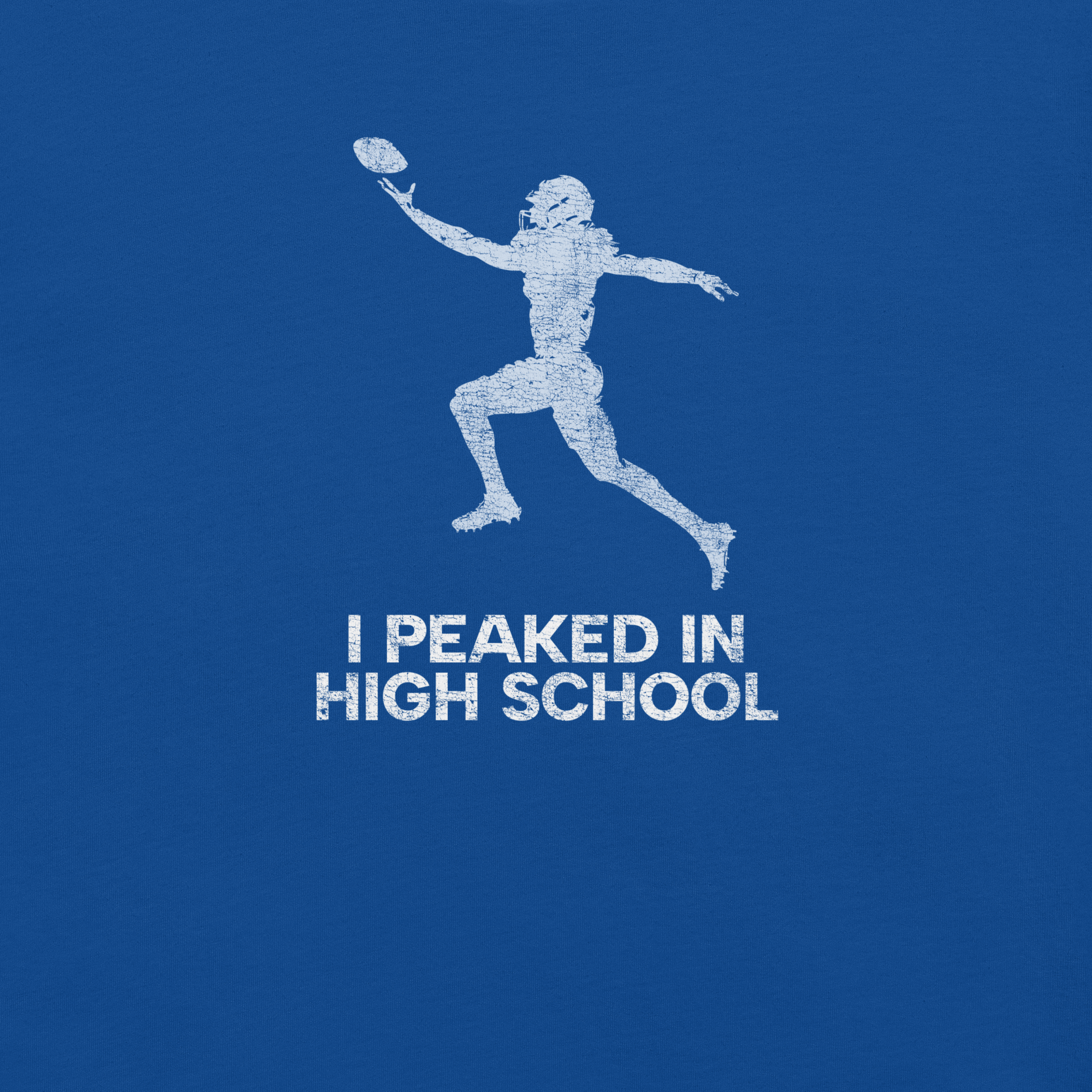 Close-up of true royal Milk Sandwich T-shirt with distressed white football player graphic and text I Peaked in High School, ironic athletic nostalgia tee.