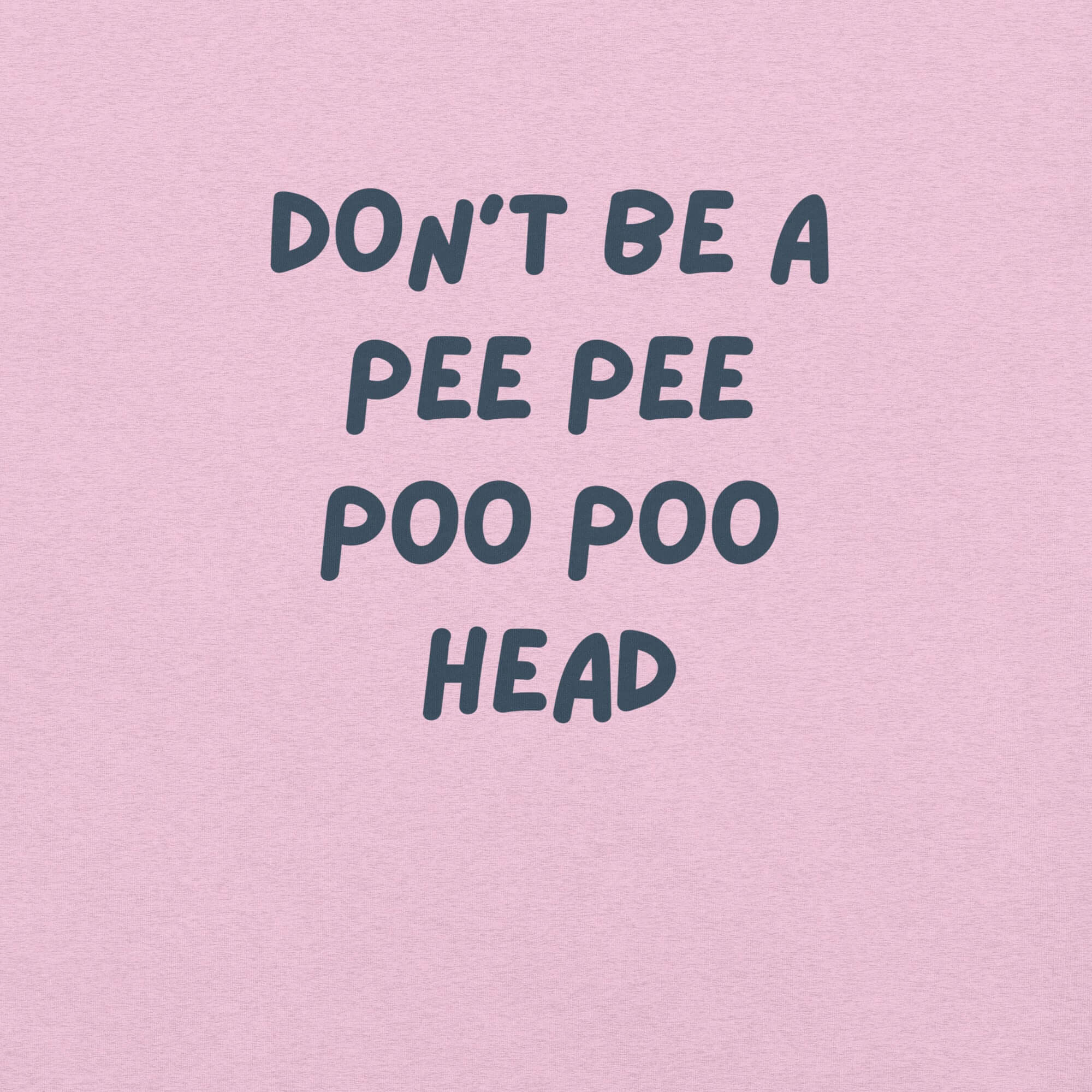 Man wearing lilac “DON’T BE A PEE PEE POO POO HEAD” t-shirt, standing casually with hands by pockets.