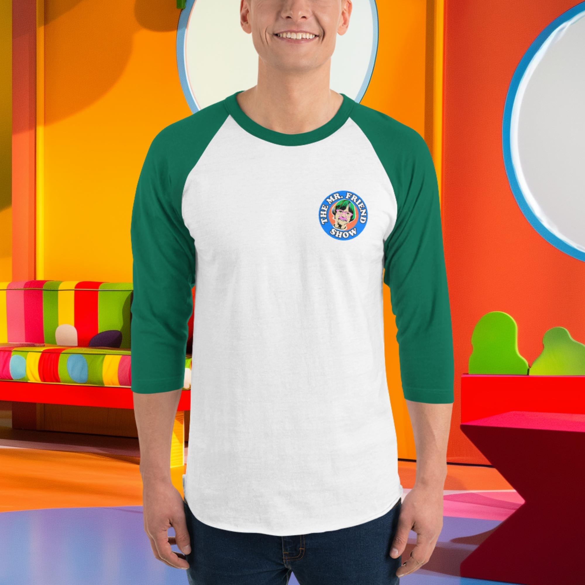 Man wearing The Mr. Friend Show 3/4 sleeve raglan shirt, featuring green contrast sleeves and a playful logo in a colorful setting.