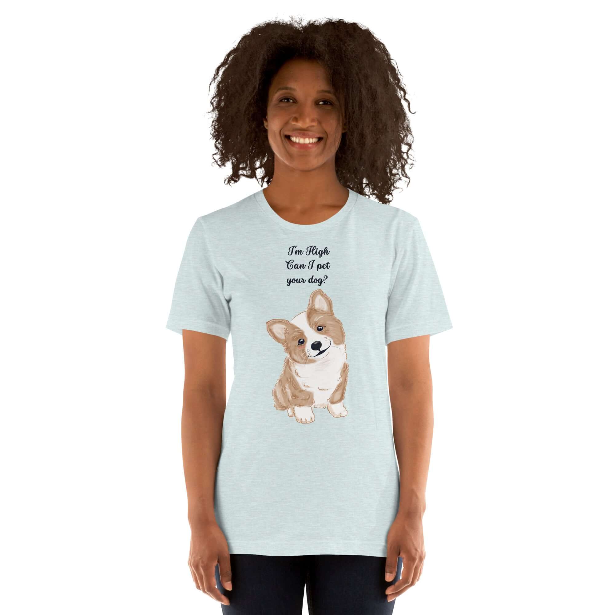 Woman wearing a light blue t-shirt with &quot;I&#39;m High, Can I pet your dog?&quot; text and a cute corgi illustration.