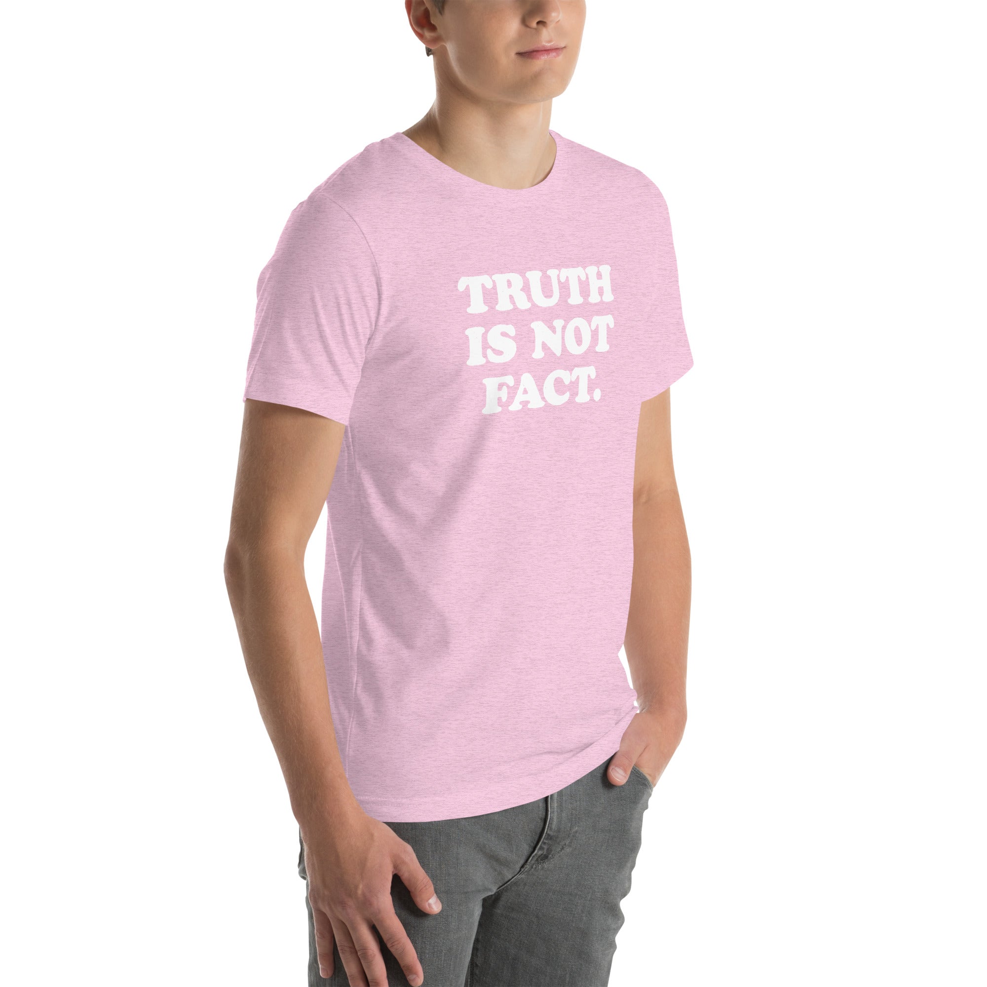 Unisex pink t-shirt with &quot;TRUTH IS NOT FACT&quot; slogan, showcasing soft, stretchy fabric and a flattering fit.