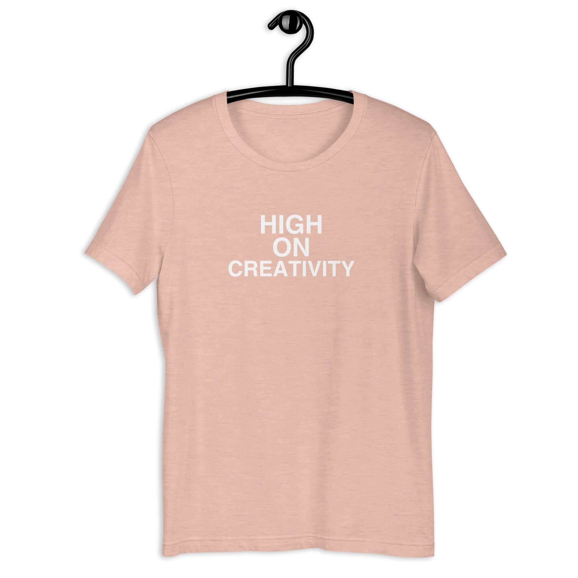 Peach t-shirt on a hanger with the phrase “HIGH ON CREATIVITY” printed in white, centered on the chest.