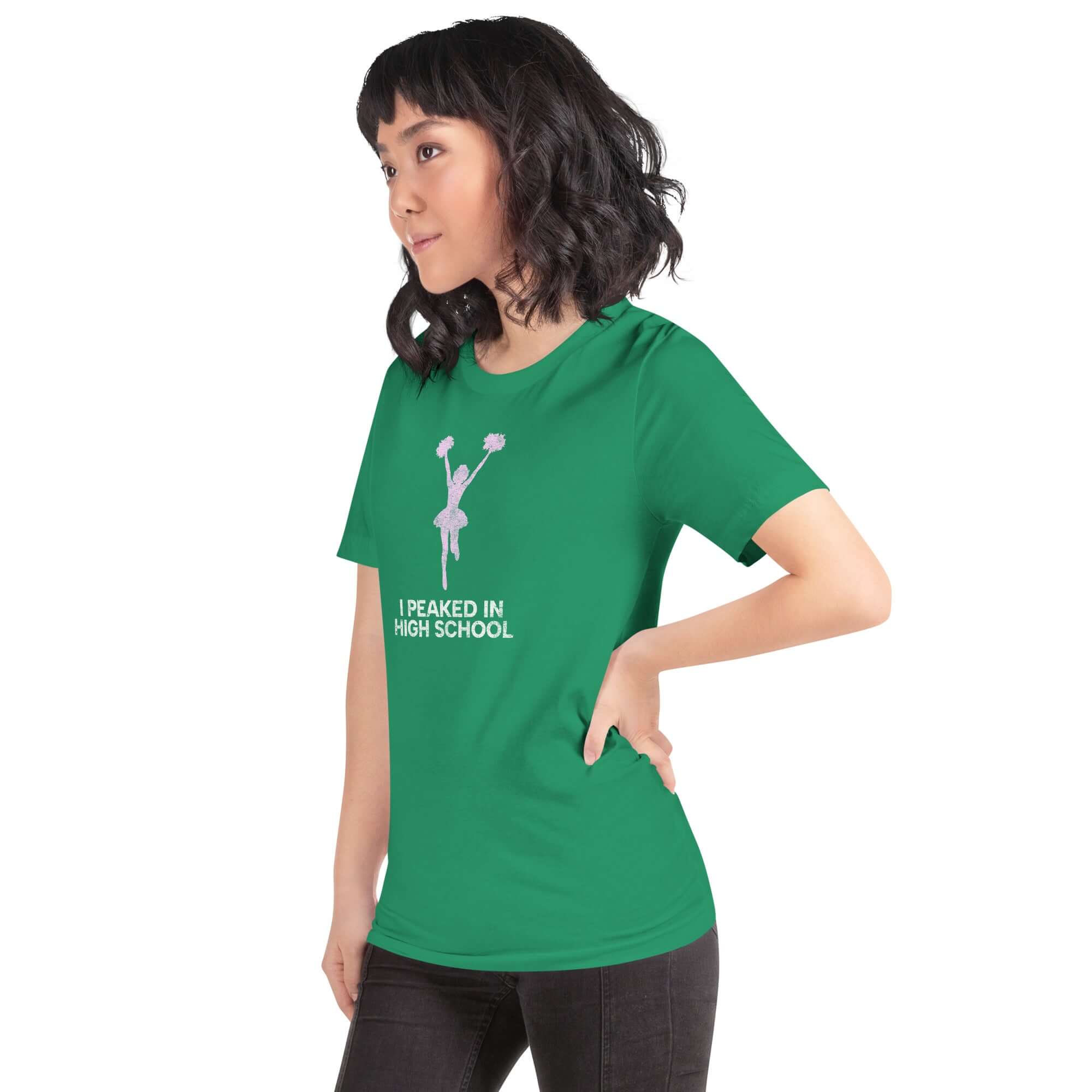 Model wearing a green unisex t-shirt that says &quot;I Peaked in High School,&quot; showcasing its comfortable fit and fun design.