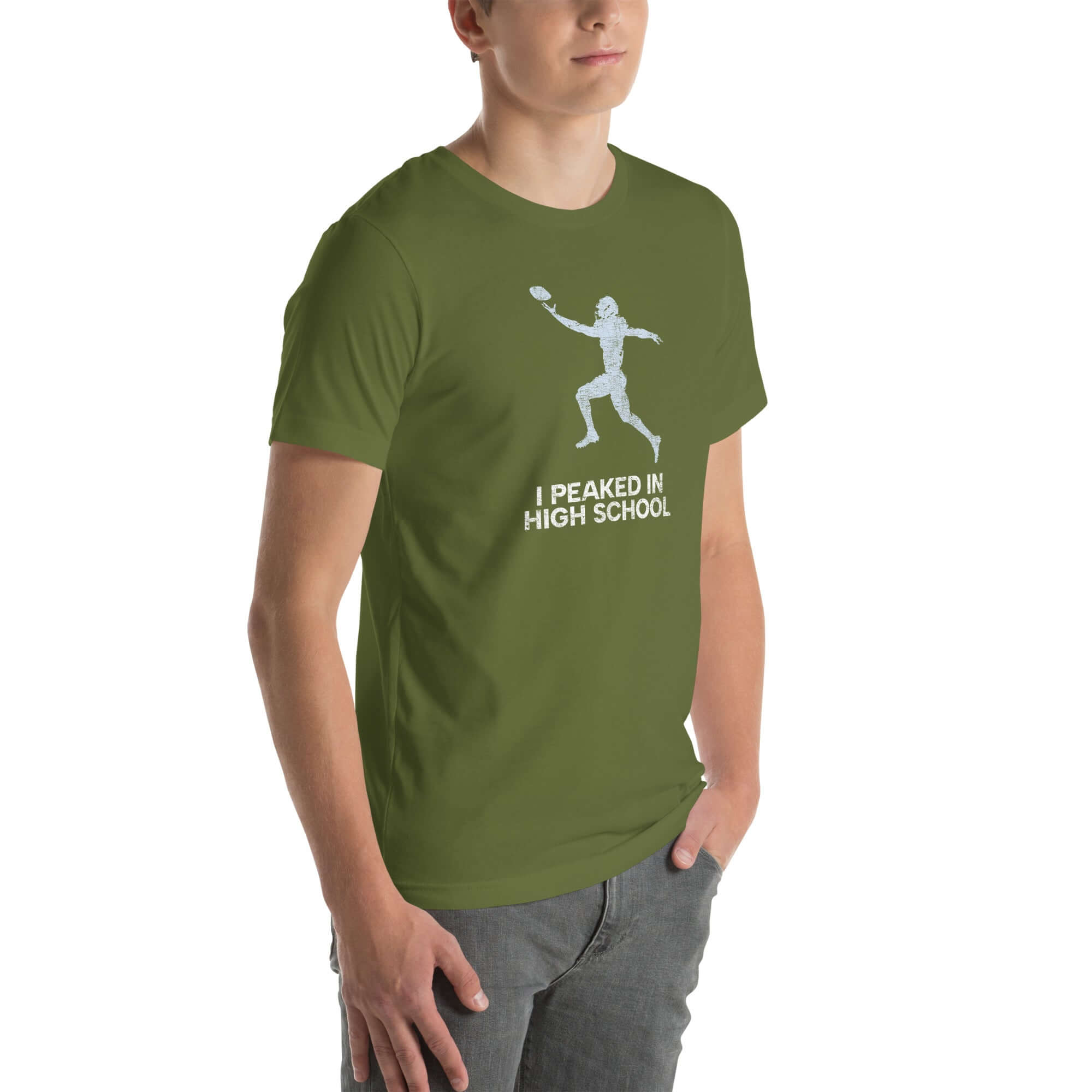 Man wearing an olive green &quot;I Peaked in High School Football&quot; t-shirt with a fun football graphic. Perfect for sports lovers!