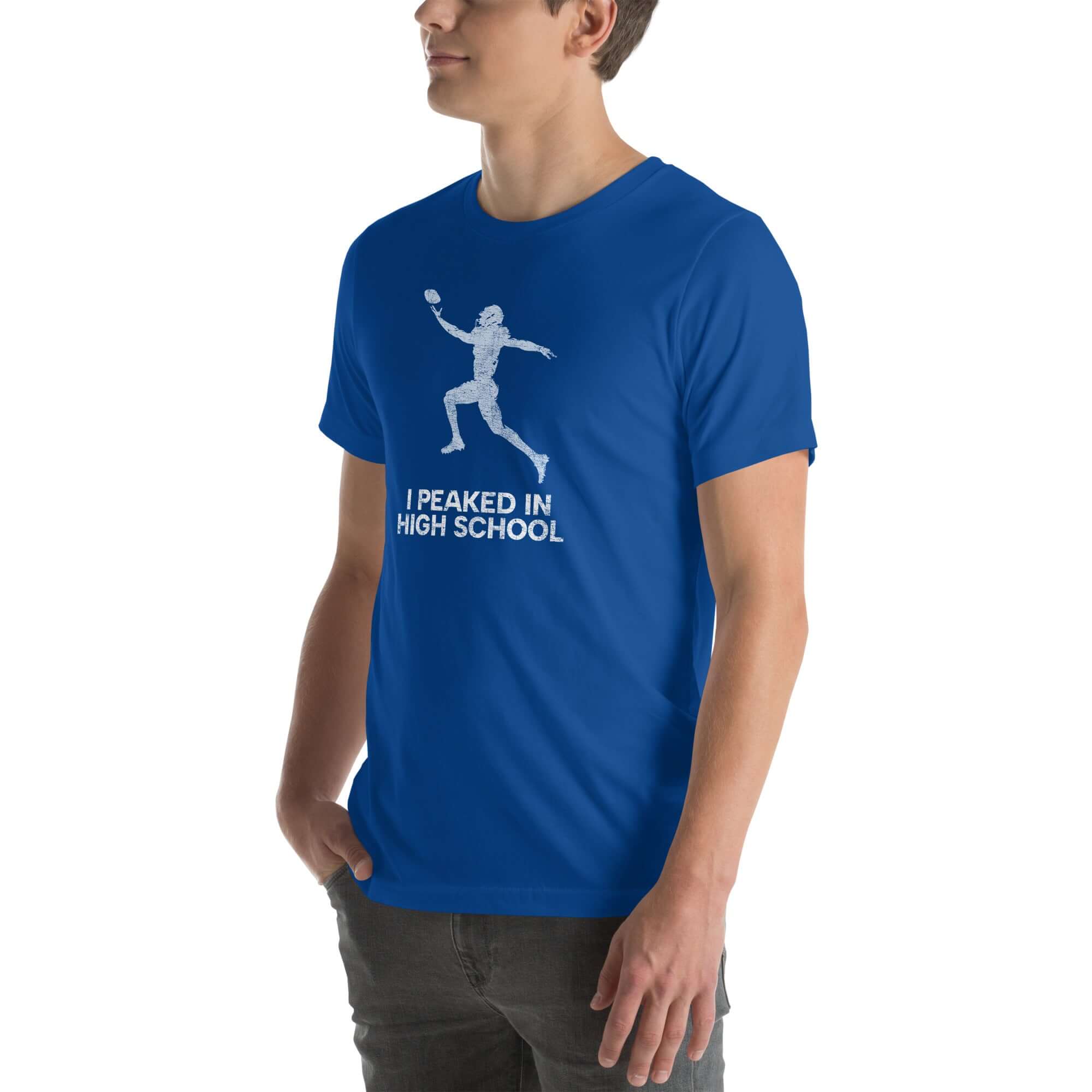 Unisex blue t-shirt featuring &quot;I Peaked In High School Football&quot; graphic, perfect for sports fans and nostalgia lovers.